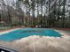 Community pool with a cover surrounded by trees and landscaping near the tennis court at 2201 Cumberland Se Ct, Smyrna, GA 30080