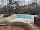 Community pool with a cover surrounded by trees and landscaping at 2201 Cumberland Se Ct, Smyrna, GA 30080