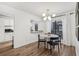 Bright dining area with round table, modern lighting, and white walls, adjacent to the kitchen at 2201 Cumberland Se Ct, Smyrna, GA 30080