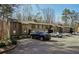 Apartment complex shows an ample parking area with multiple parked vehicles and mature trees at 2201 Cumberland Se Ct, Smyrna, GA 30080