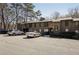 Apartment complex with a large parking lot and well-maintained landscaping with mature trees at 2201 Cumberland Se Ct, Smyrna, GA 30080