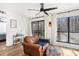 Living room shows seating area with hardwood floors, ceiling fan, view of back patio and access to another room at 2201 Cumberland Se Ct, Smyrna, GA 30080