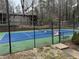 Community tennis court with blue surface and surrounding fence at 2201 Cumberland Se Ct, Smyrna, GA 30080