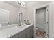 Modern bathroom with gray vanity, white subway tile, and a large mirror at 3939 Glenview Club Ln, Duluth, GA 30097