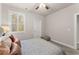 Bedroom with a queen bed, ceiling fan, and window with plantation shutters at 3939 Glenview Club Ln, Duluth, GA 30097