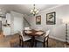 Bright dining room features a round table with four chairs, hardwood floors and stylish wall art at 3939 Glenview Club Ln, Duluth, GA 30097