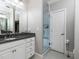 Bathroom with granite countertop, white cabinets and a glass shower at 62 Emerson Hill Sq, Marietta, GA 30060