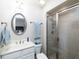 Clean bathroom with a single vanity, shower, and a framed mirror at 62 Emerson Hill Sq, Marietta, GA 30060