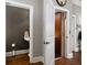 Small powder room with pedestal sink and dark-colored walls at 62 Emerson Hill Sq, Marietta, GA 30060