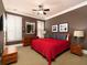 Main bedroom with red bedding, hardwood floors and ensuite bathroom at 62 Emerson Hill Sq, Marietta, GA 30060