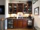 Well-stocked wet bar with granite countertop, glass cabinets, and a wine rack at 62 Emerson Hill Sq, Marietta, GA 30060