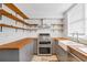 Modern kitchen with stainless steel appliances and butcher block counters at 868 E Ponce De Leon Ave, Decatur, GA 30030