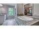Bathroom with granite countertop, soaking tub and walk-in shower at 121 Frontier Way, Mcdonough, GA 30253