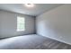 Simple bedroom with grey carpet and a window at 121 Frontier Way, Mcdonough, GA 30253
