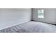 Well-lit bedroom featuring grey carpeting and a window at 121 Frontier Way, Mcdonough, GA 30253