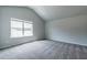Bedroom with vaulted ceiling, carpet, and a large window at 121 Frontier Way, Mcdonough, GA 30253