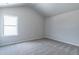 Bright bedroom with vaulted ceiling, carpet, and window at 121 Frontier Way, Mcdonough, GA 30253