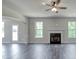 Gathering room with hardwood floors, fireplace and a ceiling fan at 121 Frontier Way, Mcdonough, GA 30253