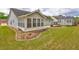 Landscaped backyard with patio, sunroom, and storage shed at 160 Valley Brook Dr, Covington, GA 30016