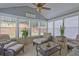 Relaxing sunroom with tiled floor, ample seating, and large windows at 160 Valley Brook Dr, Covington, GA 30016