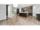 Open kitchen with island, gray cabinets, and a view of the living room at 2357 Rover Ct, Atlanta, GA 30317