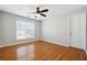 Bright bedroom with hardwood floors and ceiling fan at 2421 Merrion Park Ct, Dacula, GA 30019