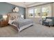 Spacious primary bedroom with large windows and plush carpeting at 525 Nolden Trl, Dacula, GA 30019