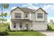 Two-story home with light brick and vinyl siding, a two-car garage and landscaping at 525 Nolden Trl, Dacula, GA 30019