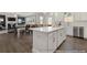 Open concept kitchen with island, stainless steel appliances, and white cabinetry at 525 Nolden Trl, Dacula, GA 30019
