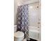 Bathroom with shower/tub combo and gray shower curtain at 6467 Century Park Se Pl, Mableton, GA 30126