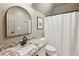 Stylish bathroom with granite countertop and arched mirror at 1052 Brookhaven Ne Walk, Brookhaven, GA 30319