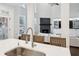 Kitchen island with sink, breakfast bar, and view into Gathering room at 1052 Brookhaven Ne Walk, Brookhaven, GA 30319