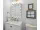 Stylish powder room with white vanity, decorative mirror, and blue floral wallpaper at 1052 Brookhaven Ne Walk, Brookhaven, GA 30319