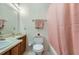 Clean bathroom with light wood cabinets and a pink shower curtain at 1945 Brian Way, Decatur, GA 30033