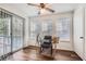 Bright home office with glass desk, hardwood floors, and access to a balcony at 1945 Brian Way, Decatur, GA 30033