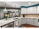 Modern kitchen with gray cabinets and quartz countertops at 200 River Vista Dr # 427, Atlanta, GA 30339