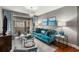 Living room with teal sofa and hardwood floors at 200 River Vista Dr # 427, Atlanta, GA 30339