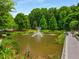 Serene pond with fountain and walking path at 200 River Vista Dr # 427, Atlanta, GA 30339