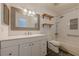 Modern bathroom with a large mirror, floating shelves, and shower-tub combination with sleek finishes at 2698 Farmstead Se Rd, Smyrna, GA 30080