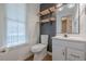 Simple bathroom with white vanity, toilet and floating shelves at 2698 Farmstead Se Rd, Smyrna, GA 30080