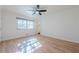 Bright bedroom with hardwood floors, ceiling fan, and a window providing natural light at 2698 Farmstead Se Rd, Smyrna, GA 30080