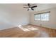 Sunny bedroom features hardwood floors, a ceiling fan, and a window that fills the space with natural light at 2698 Farmstead Se Rd, Smyrna, GA 30080