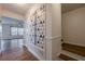 Elegant hallway with hardwood floors, decorative wall paneling, and a glimpse into the adjacent living space at 2698 Farmstead Se Rd, Smyrna, GA 30080