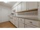 White kitchen cabinets, granite countertops, and a farmhouse sink at 2698 Farmstead Se Rd, Smyrna, GA 30080