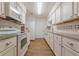 Bright kitchen featuring all white cabinets, stainless steel appliances, and subway tile backsplash at 2698 Farmstead Se Rd, Smyrna, GA 30080