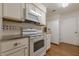 White appliances and granite countertops in this galley kitchen at 2698 Farmstead Se Rd, Smyrna, GA 30080