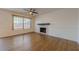 Bright living room featuring a fireplace, ceiling fan and gleaming hardwood floors at 2698 Farmstead Se Rd, Smyrna, GA 30080