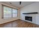 Comfortable room featuring a wood-burning fireplace and a large window for natural light at 2698 Farmstead Se Rd, Smyrna, GA 30080