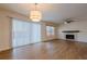 Bright living room featuring a fireplace, ceiling fan, and sliding glass doors at 2698 Farmstead Se Rd, Smyrna, GA 30080