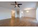 Open living room with hardwood floors, a ceiling fan, and view to the kitchen at 2698 Farmstead Se Rd, Smyrna, GA 30080